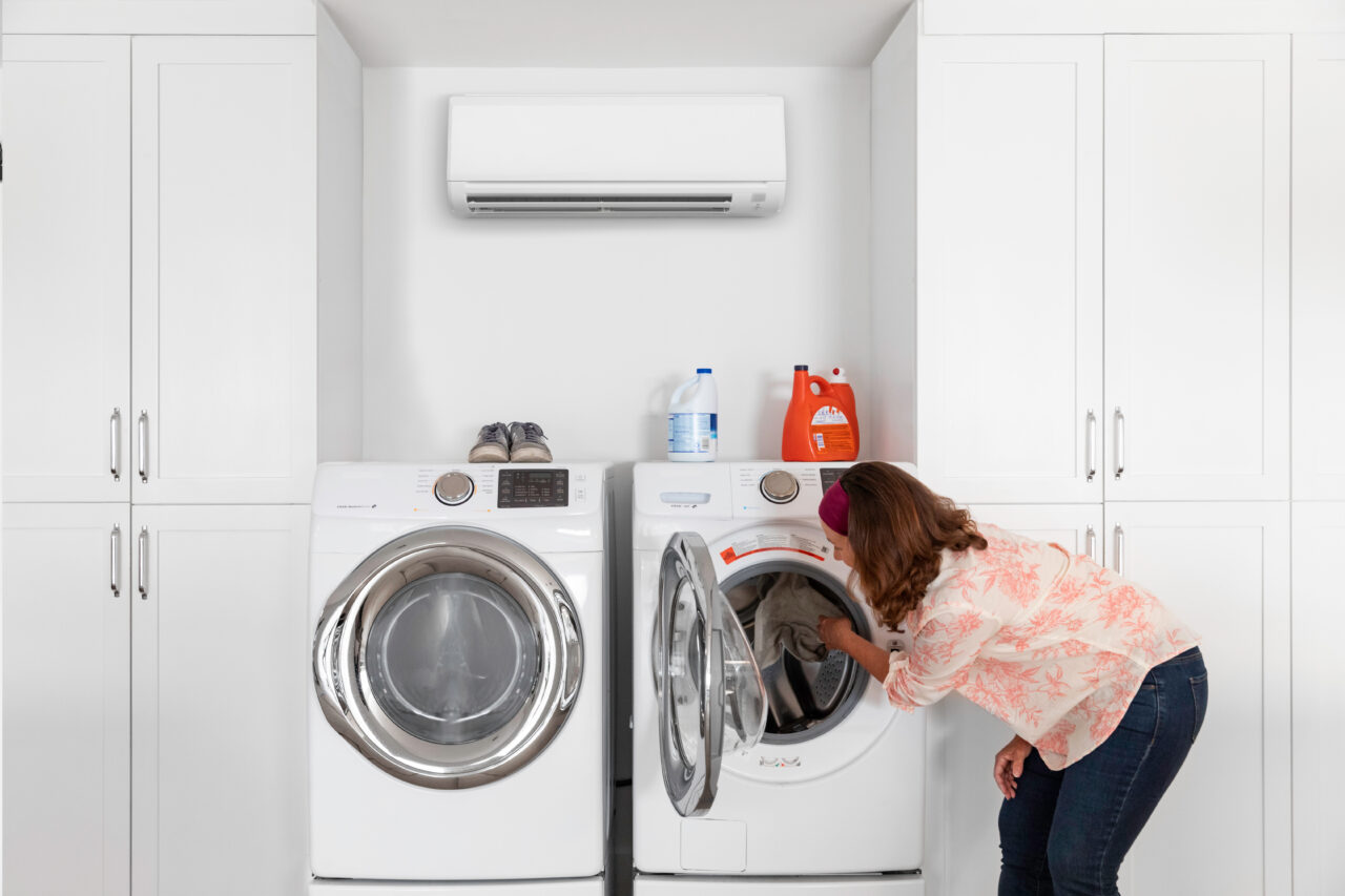 Woman in Laundry Room with Heat Pump