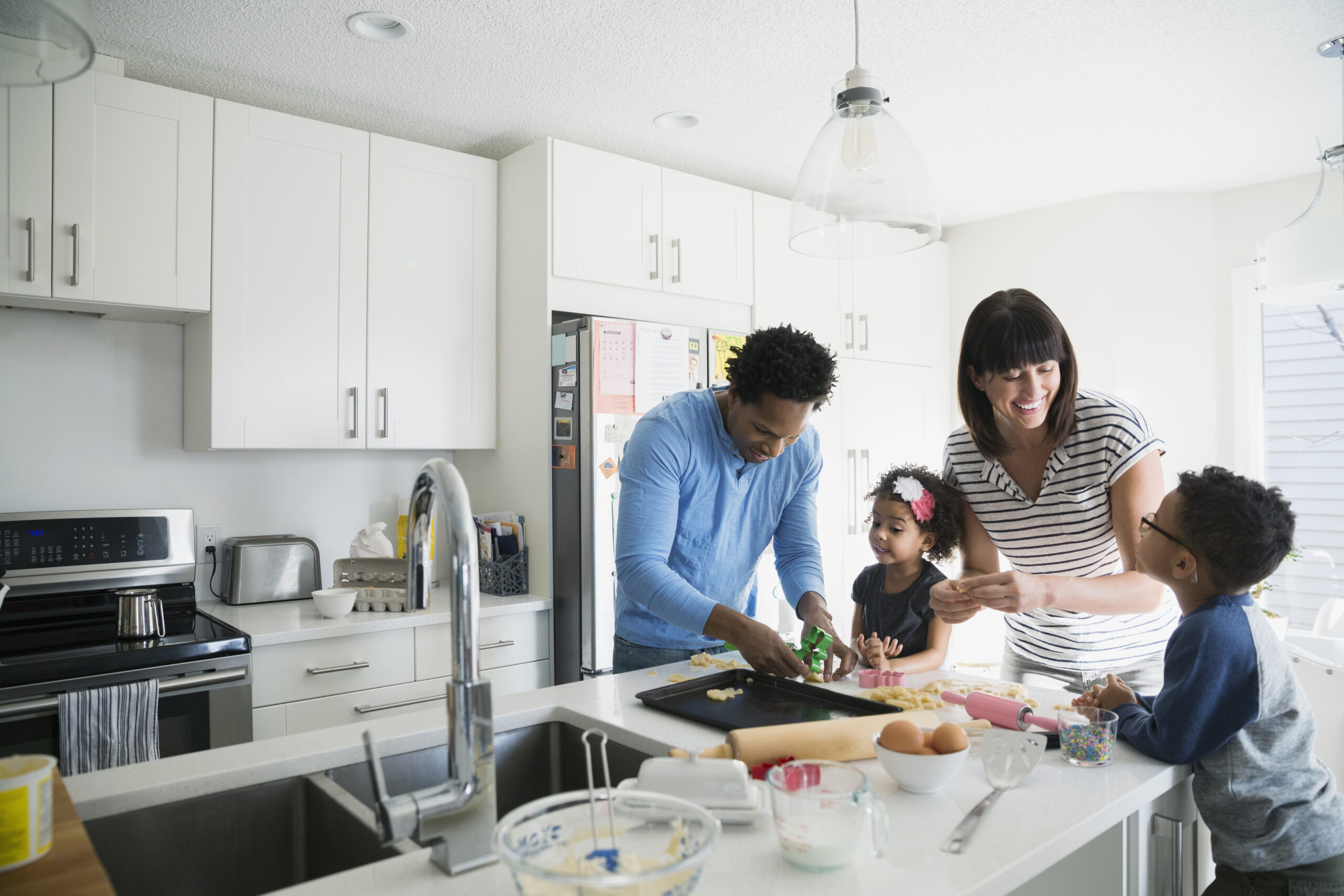Family baking cookies in kitchen