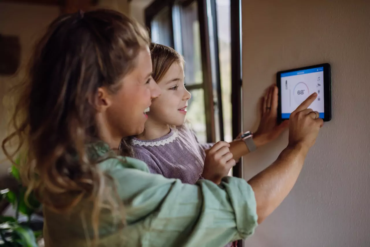 Woman and Child with Smart Thermostat