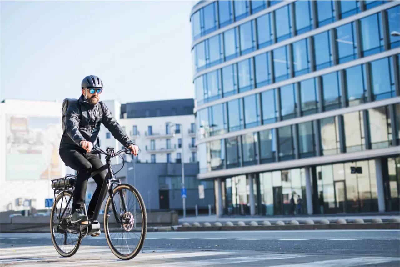 Man Riding E-Bike on City Street